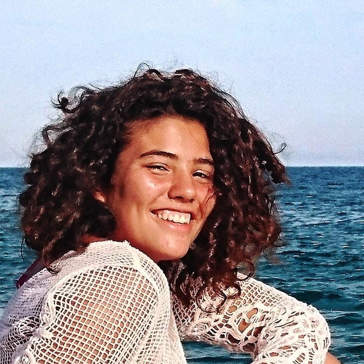 Kaveri Mehta, Lead Design Curator at PlainsWhisperOak, reviewing corporate floral arrangements